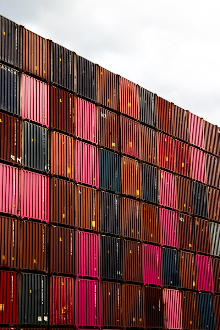 Stacked cargo containers in vibrant colors at Hamburg port.
