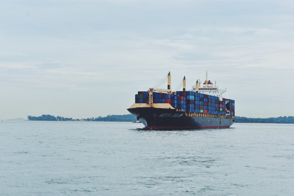 Mastering the First Impression: Your intriguing post title goes here Large cargo ship transporting containers across a calm sea, symbolizing global logistics.